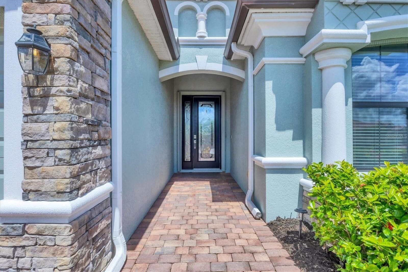 Stone and stucco entrance path to the front door