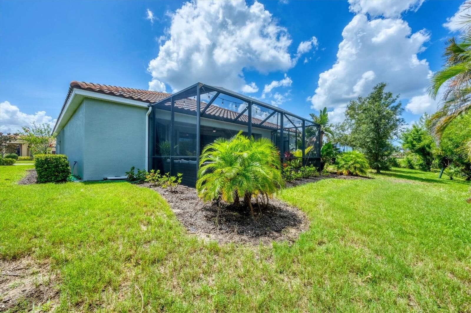 The glass-enclosed lanai from the garden