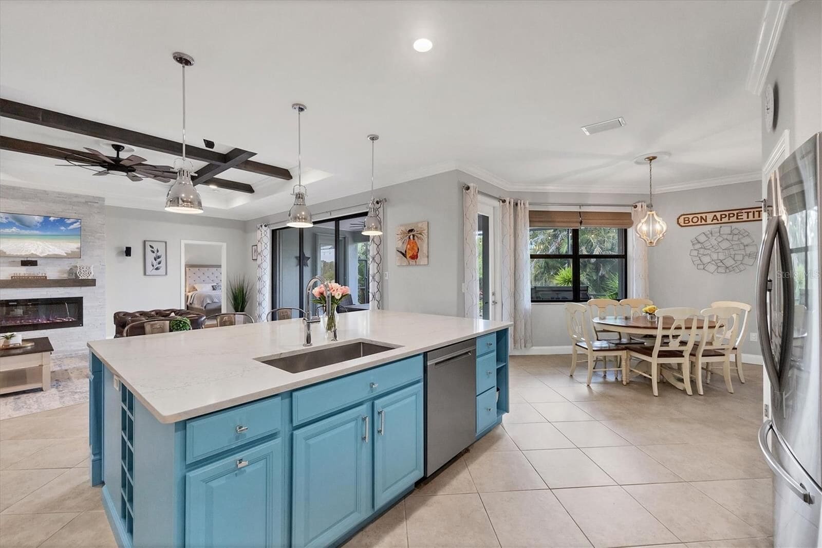 Kitchen with blue cabinets, island and dining table
