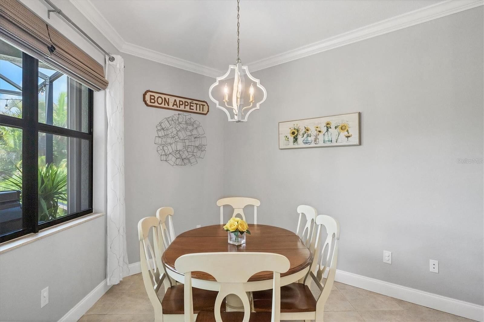 Dining area with chandelier and wall art