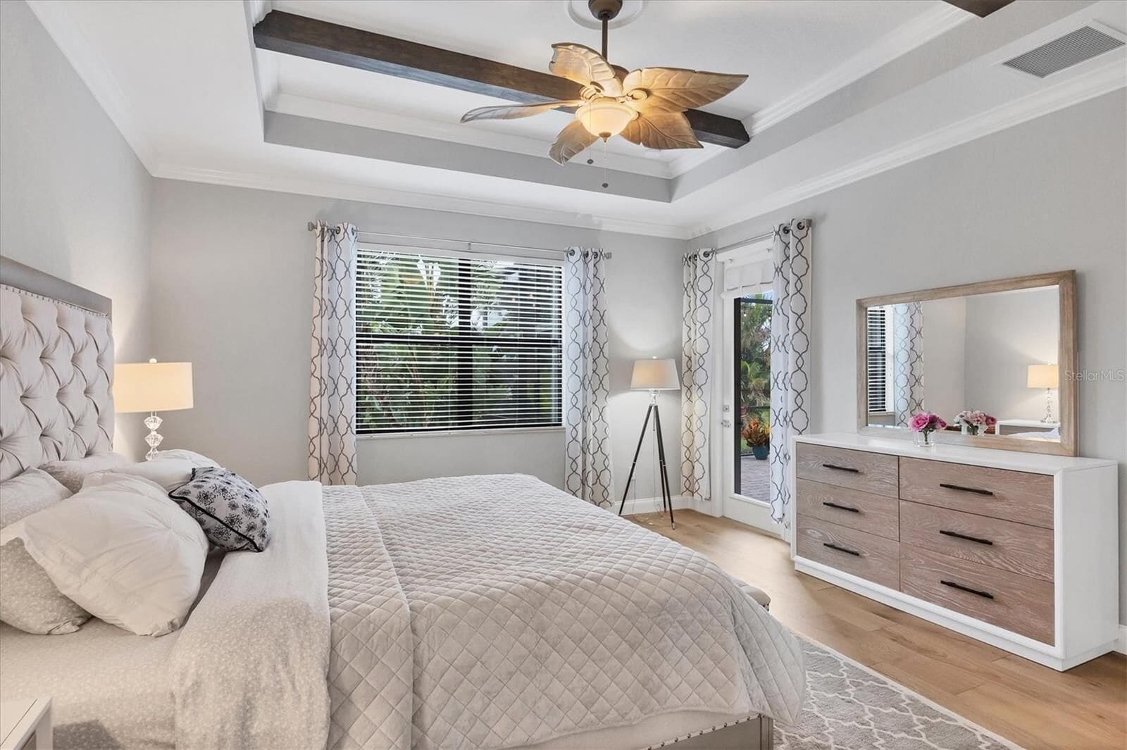 Bedroom with dresser and curtained window