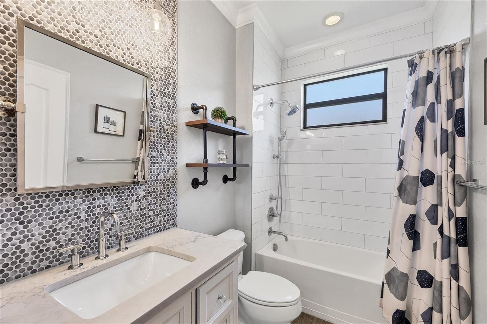 Bathroom with a walk-in shower and hexagonal tile