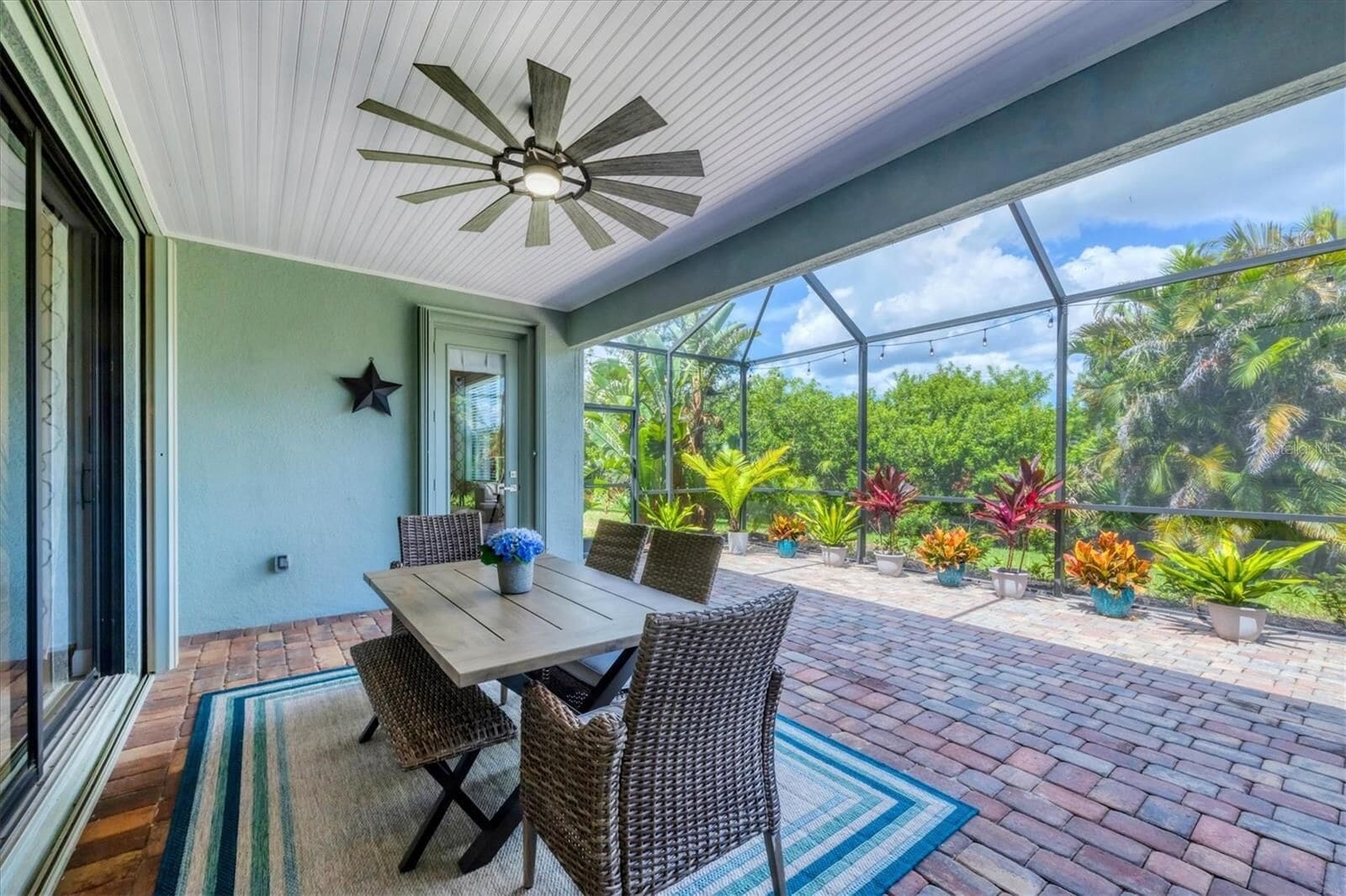 Lanai dining table surrounded by planting