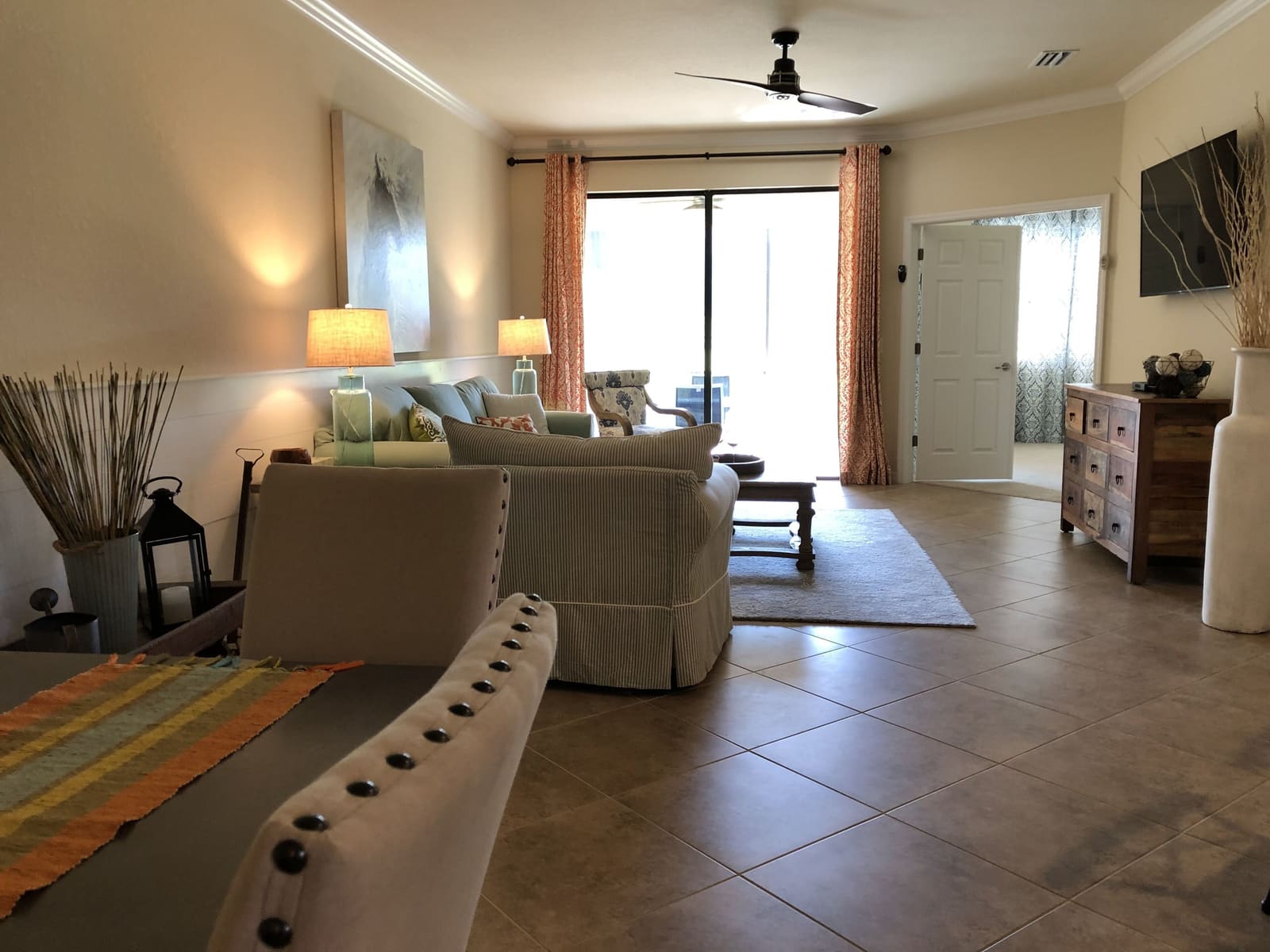 Living room seating with the TV and door out to the porch