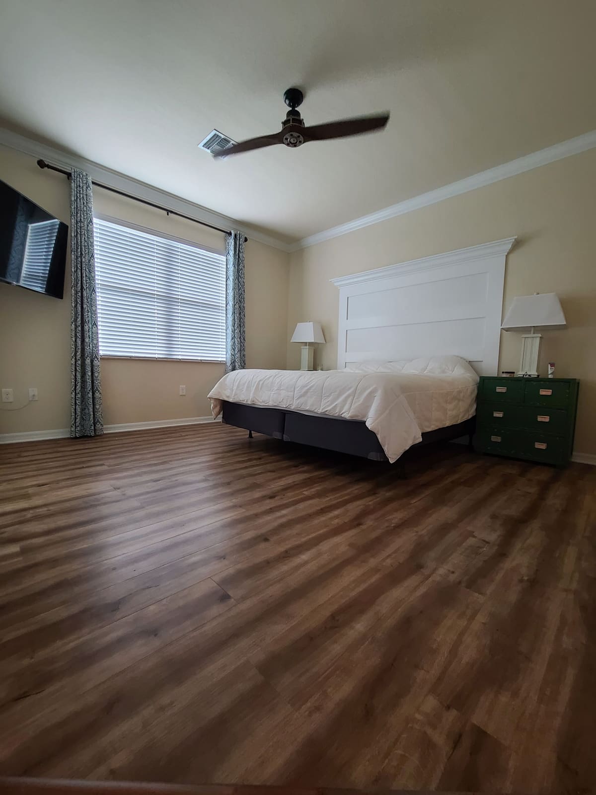 Bedroom with a ceiling fan and blinds