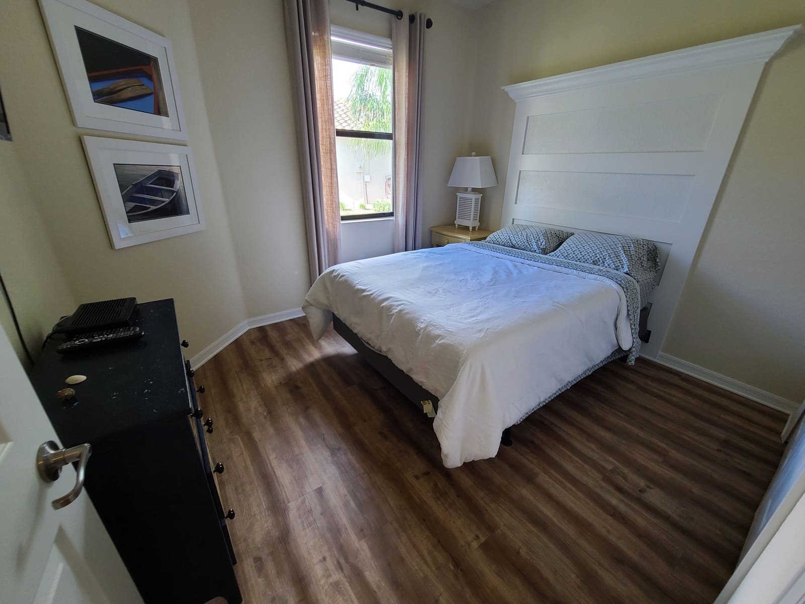 Second bedroom with wooden flooring and bedside lamp
