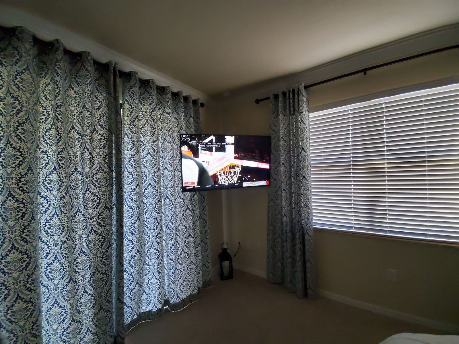 Bedroom with a TV and floor lamp