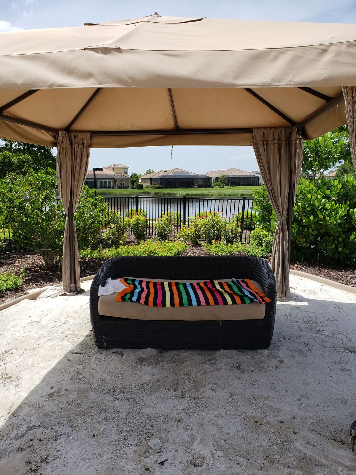 Screened porch with cushioned bench, looking over the water